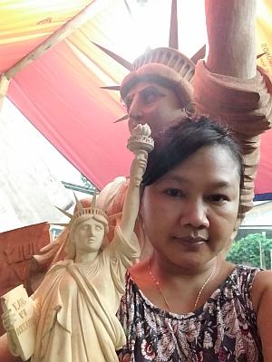 CEO Lismawati Kohar Abdullah with big and small wooden statues of liberty